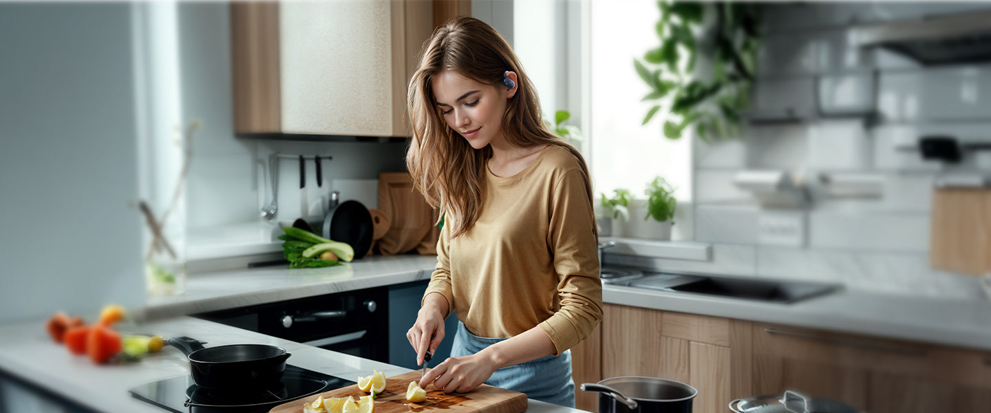 A woman slicing lemon wearing blue earbuds.