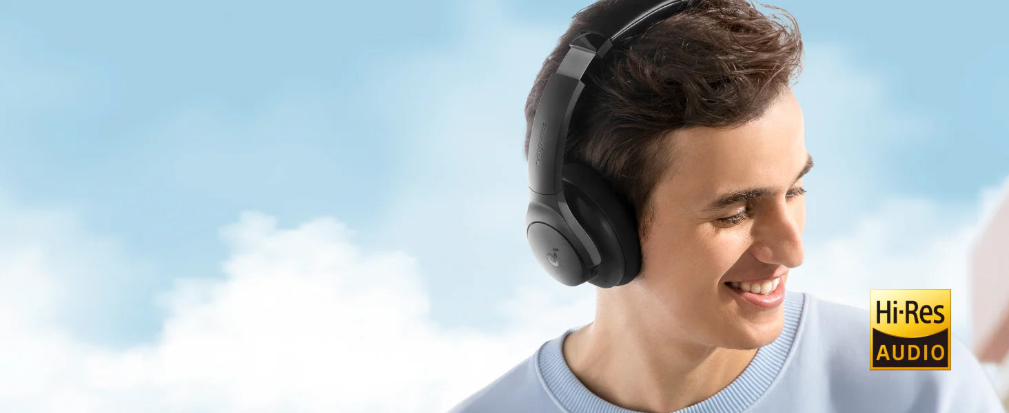 Man wearing headphones with a clear blue sky background